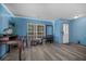 Bright blue living room featuring modern flooring, a large window, and stylish decor at 406 Brookfield Ln, Goose Creek, SC 29445