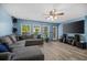 Spacious living room with ample seating, large windows, and modern entertainment setup at 406 Brookfield Ln, Goose Creek, SC 29445