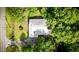 Aerial view of a brick home featuring a metal roof and surrounding mature trees at 416 Altman St, Moncks Corner, SC 29461