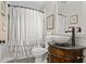 Charming bathroom features a ruffled shower curtain, patterned tile, and granite countertop at 416 Altman St, Moncks Corner, SC 29461