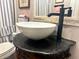 This bathroom has a modern faucet and a white bowl sink on an antique vanity at 416 Altman St, Moncks Corner, SC 29461