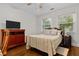 This cozy bedroom features wood floors, light walls, two windows, and a ceiling fan at 416 Altman St, Moncks Corner, SC 29461