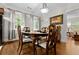 Elegant dining room with a traditional table, chairs, and ample natural light from surrounding windows at 416 Altman St, Moncks Corner, SC 29461