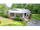Lovely single-story brick home with a covered porch, manicured lawn, and a metal roof at 416 Altman St, Moncks Corner, SC 29461