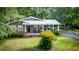 Charming brick home with a metal roof, inviting front porch and well-manicured lawn at 416 Altman St, Moncks Corner, SC 29461