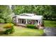 Beautiful brick home with a metal roof, cozy front porch, and landscaped yard at 416 Altman St, Moncks Corner, SC 29461