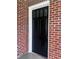 Classic black front door with sidelights, set in a traditional brick facade at 416 Altman St, Moncks Corner, SC 29461