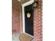 Welcoming front entrance with a black door, brick facade, and a charming decorative wreath at 416 Altman St, Moncks Corner, SC 29461