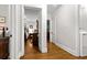 Hallway leading to the bedroom and bathroom, featuring hardwood floors and fresh, white walls at 416 Altman St, Moncks Corner, SC 29461