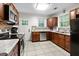 Functional kitchen offers stainless steel appliances, updated cabinets, and tile floor, providing a practical cooking area at 416 Altman St, Moncks Corner, SC 29461