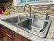 Close-up on a stainless steel kitchen sink with a modern faucet and attractive granite countertops at 416 Altman St, Moncks Corner, SC 29461