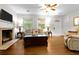 Bright living room featuring hardwood floors, a fireplace, and large windows providing natural light at 416 Altman St, Moncks Corner, SC 29461