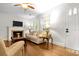 Well-lit living room featuring hardwood floors, a fireplace, and comfortable, traditional furnishings at 416 Altman St, Moncks Corner, SC 29461