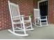 Two classic white rocking chairs sit on the front porch of a brick home at 416 Altman St, Moncks Corner, SC 29461
