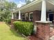 Charming porch of a brick home with classic white columns and comfortable rocking chairs at 416 Altman St, Moncks Corner, SC 29461