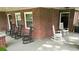 Relaxing front porch features brick columns and classic rocking chairs at 416 Altman St, Moncks Corner, SC 29461