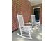 Close-up of front porch with two rocking chairs and a black front door at 416 Altman St, Moncks Corner, SC 29461