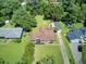 Aerial shot displays the home's backyard with fire pit and shed, mature trees, well-kept lawn, and the surrounding neighborhood at 422 Geddes Ave, Charleston, SC 29407