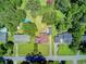 An aerial view of the property showcasing the house, large backyard with pool, surrounding trees, and neighborhood at 422 Geddes Ave, Charleston, SC 29407