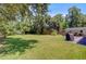 Expansive backyard featuring a lush lawn, mature trees, and a charming outdoor structure for relaxing or entertaining at 422 Geddes Ave, Charleston, SC 29407