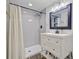 Well-lit bathroom with a shower, vanity, framed mirror, tiled walls, and classic decor elements at 422 Geddes Ave, Charleston, SC 29407
