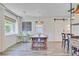 Well-lit dining room featuring a large wooden table, sliding barn door, and a view to the backyard at 422 Geddes Ave, Charleston, SC 29407
