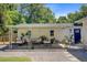 Covered patio with an outdoor seating area including plush chairs, sofa, and potted plants at 422 Geddes Ave, Charleston, SC 29407