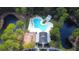 Aerial view of a community pool, clubhouse, playground, and surrounding landscape at 4969 Franconia Dr, Summerville, SC 29485