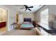 Bedroom featuring a ceiling fan, an ensuite bathroom, a window, and neutral carpeting at 4969 Franconia Dr, Summerville, SC 29485