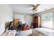 Bedroom featuring a ceiling fan, large window, and a cozy sitting area with a brown leather chair at 4969 Franconia Dr, Summerville, SC 29485