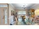 Formal dining room features a large glass table, stylish chandelier, and charming decor at 4969 Franconia Dr, Summerville, SC 29485