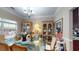 Charming dining room with a glass table, decorative hutches, and warm natural light at 4969 Franconia Dr, Summerville, SC 29485