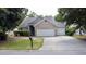 Charming single-story home featuring a well-manicured lawn and a three car garage at 4969 Franconia Dr, Summerville, SC 29485