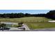 Wide aerial view displaying the golf course and practice facilities set amidst trees at 4969 Franconia Dr, Summerville, SC 29485