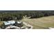 Aerial view of a meticulously maintained golf course with lush green fairways surrounded by mature trees at 4969 Franconia Dr, Summerville, SC 29485