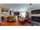 Open living space with hardwood floors, a fireplace, and a view into the well-equipped kitchen at 4969 Franconia Dr, Summerville, SC 29485