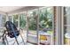 View of the screened-in porch with an outdoor grill and a view of the wooded backyard at 4969 Franconia Dr, Summerville, SC 29485