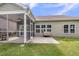 Backyard featuring a screened porch, concrete patio with a loveseat, manicured lawn, and siding on the home at 519 Tarleton Dr, Summerville, SC 29483