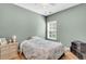 Cozy bedroom with hardwood floors, ceiling fan, side table, and floral bedding at 519 Tarleton Dr, Summerville, SC 29483