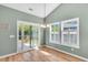 Dining room with a chandelier, wood floors, windows with shutters, and sliding glass doors at 519 Tarleton Dr, Summerville, SC 29483