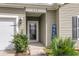 Close-up of the front entry with a decorative door, house number, and lush landscaping at 519 Tarleton Dr, Summerville, SC 29483