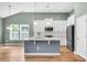 Modern kitchen with stainless steel appliances, an island, and a view into the living room at 519 Tarleton Dr, Summerville, SC 29483