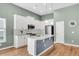 Modern kitchen with white cabinets, stainless steel appliances, and an island at 519 Tarleton Dr, Summerville, SC 29483