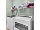Well-equipped laundry room with washer, dryer, and ample storage shelves at 519 Tarleton Dr, Summerville, SC 29483