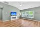 Cozy living room with a fireplace, television, and large windows with plantation shutters at 519 Tarleton Dr, Summerville, SC 29483