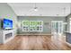 Bright living room features hardwood floors, a ceiling fan, and a modern fireplace with television at 519 Tarleton Dr, Summerville, SC 29483