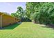 A sprawling backyard features lush green grass and mature trees, perfect for outdoor enjoyment at 7 Plainfield Dr, Charleston, SC 29407