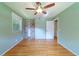 Bedroom featuring hardwood floors, ceiling fan, and windows with a lush view at 7 Plainfield Dr, Charleston, SC 29407