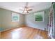 Well-lit bedroom featuring hardwood floors, windows, and a ceiling fan at 7 Plainfield Dr, Charleston, SC 29407