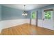 Bright dining room with blue walls, hardwood floors, and classic chandelier fixture at 7 Plainfield Dr, Charleston, SC 29407